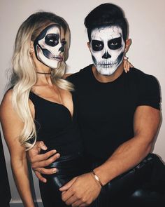 a man and woman in skeleton makeup posing for a photo with their arms around each other