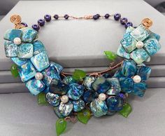 Floral Bib Necklace - Shell Pearl Flower Necklace - Blue Statement Necklace - Flower Garland Necklace - June Birthstone - Flower Bib_______________________A striking floral bib style necklace using shell Pearls with bare copper and elements of Swarovski crystals. The flowers are secured on to a wired base with lucite leaves. Bare copper improves as it ages. The necklace has a nice weight to the piece and would be perfect to wear over jumpers or an unbuttoned shirt. Choice of colour - Blues or Pi Unbuttoned Shirt, Pearl Flower Necklace, Rustic Bracelet, Multi Gemstone Bracelet, Necklace Shell, Blue Statement Necklace, Headpiece Jewelry, Body Adornment, Necklace Flower