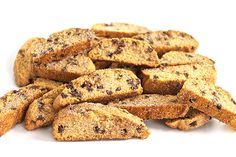 a pile of chocolate chip cookies sitting on top of a white table next to each other