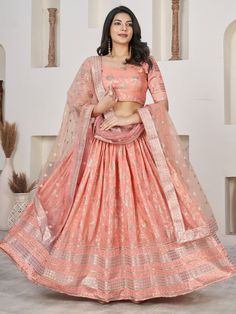 This stunning ensemble features a peach color jacquard lehenga with intricate zari embroidered work and sequin detailing. The matching jacquard choli complements the lehenga beautifully, adorned with the same zari embroidered work and sequin embellishments. Completing the look is a net dupatta in a similar peach shade, featuring four-side embroidered lace work for an elegant touch.
This ensemble includes exquisite zari embroidered work and sequin detailing, adding a touch of sparkle and gl Navratri Traditional Drape Sets In Peach, Fitted Embroidered Peach Lehenga, Navratri Peach Sets In Traditional Drape, Traditional Drape Peach Sets For Navratri, Peach Embroidered Lehenga, Eid Peach Semi-stitched Lehenga, Festive Embroidered Peach Lehenga, Peach Sets With Pallu In Traditional Drape, Fitted Peach Sets For Festive Occasions