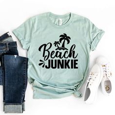 "Beach Junkie T-shirt, Beach Shirt, Spring Top, Glamping Gift, Adventurer Tee, Fisherman Shirt, Beach Lover T-shirt, Boating Gift, Summer Vacation Tee, Adventure Shirt, Beach Shirt, Summer Shirt, Surfing Shirt, Travel Shirt, Vacation Shirt, Women's Beach Shirt, Ocean Shirt, Gift For Her, Beach T-shirt, Shirt For Women, Girls Trip Shirt, Summer T-shirt This updated unisex essential fits like a well-loved favorite. Super soft cotton and excellent quality print makes one to fall in love with it over and over again. ------------- Fabrication ------------- 100% Combed ring spun cotton Made by specially treating the cotton fibers before spinning them into yarn. The result is stronger and smoother fabric. ------------- Unisex T-shirt Size Chart ------------- XS - - 27\" Length and 18\" Width S - Graphic Print Top For Beach Season, Cotton Tops For Outdoor Beach Season, Outdoor Summer T-shirt With Screen Print, Screen Print T-shirt For Summer Outdoor, Summer Outdoor Screen Print T-shirt, Beach Season Short Sleeve Tops, Beach Season Outdoor Short Sleeve Tops, Summer Tops For Beach Season Outdoor, Green Letter Print T-shirt For Camping