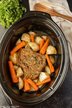 a pot filled with meat, potatoes and carrots