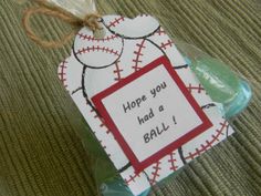 a baseball themed gift wrapped in cellophane with a tag that says, hope you had a ball