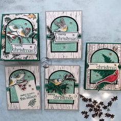 four christmas cards with birds on them and snowflakes hanging from the bottom one