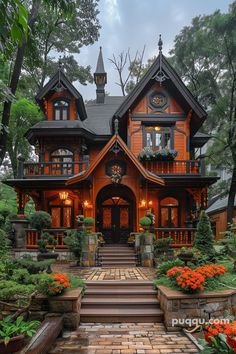 a large wooden house with lots of windows and plants on the front steps leading up to it