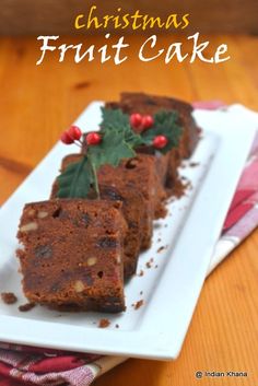 christmas fruit cake on a white plate with holly