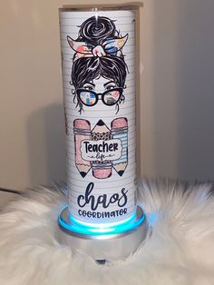 a can that is sitting on top of a white fur rug with the words teacher chaos over it