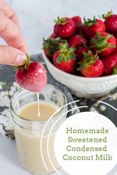 someone is dipping strawberries into a jar of coconut milk to make homemade sweetened condiments