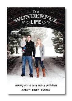 a christmas card with an image of two people and a baby in the snow,