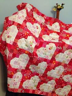 a red and white quilt with hearts on it