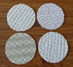 four white doily sitting on top of a wooden table