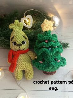 two crocheted christmas trees sitting next to each other