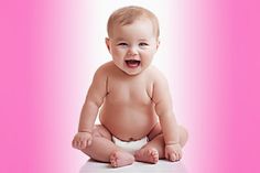 a smiling baby sitting on the floor in front of a pink background with white letters