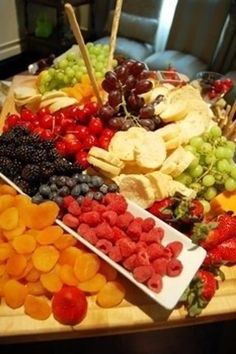 a wooden table topped with lots of different types of fruit