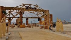 a wooden structure sitting on top of a sandy beach