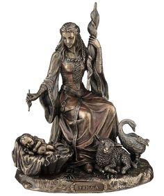 a statue of a woman sitting on top of a table next to a cat and dog