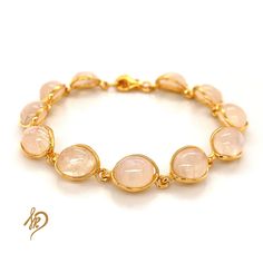 Effective Bracelet with Genuine Moonstone It is made of gold-plated 925 silver (Ag 925) We are plating our Goods with a thick layer of gold, therefore You can be satisfied with quality for ages. Standard length of this bracelet is around 18,5 cm, but there is a possibility to make it a little bit longer (up to 21 cm) because of the chain we put in the end. Bracelet is made of individual elements made of silver gold-plated and Moonstone. Cabochons measurements are 8x10 mm. Each of them may appear Adjustable Gold Rose Quartz Jewelry, Dainty Gold-plated Gemstone Bracelets, Gold Gemstone Jewelry With Rose Quartz, Yellow Gold Cabochon Bracelet As Gift, Gold Jewelry With Rose Quartz Gemstone, Rose Quartz Gemstone Gold Jewelry, Gold Rose Quartz Gemstone Jewelry, Dainty Yellow Gold Bracelet With Natural Stones, Dainty Rose Quartz Gold Jewelry