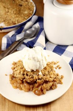 a close up of a plate of food on a table with a fork and spoon