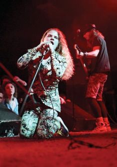 a woman on stage singing into a microphone