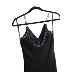 This vintage dress is a stunning piece with intricate beadwork and a timeless black color. The unique season design adds a touch of elegance to any formal occasion. Made from high-quality polyester, this dress is both comfortable and durable. It is available in a regular size type and fits perfectly for size medium. Whether you are attending a cocktail party or a formal event, this dress is perfect for any eveningwear occasion.Size MediumPit to Pit: 13.5"Length 52"-57"Waist: 15"Hip: 19" Elegant Dresses With Beaded Straps For Night Out, Elegant Formal Evening Dress With Beaded Straps, Glamorous Black Dress With Beaded Straps, Elegant Evening Dress With Beaded Straps For Party Season, Black Evening Dress With Beaded Straps, Elegant Party Dresses With Beaded Straps, Black Rhinestone Dress For Formal Occasions, Black Sleeveless Evening Dress With Rhinestones, Black Silk Dress For Prom Season