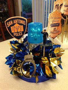 a blue police cup sitting on top of a table next to a pair of handcuffs