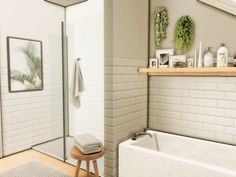 a bathroom with white tile walls and flooring next to a bathtub in the corner