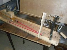 a machine that is sitting on top of a wooden table with wires attached to it