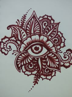 an eye is drawn on the side of a piece of paper that has been painted with red ink