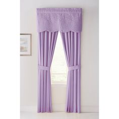 a window with purple curtains in front of it