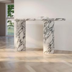 a marble table sitting on top of a hard wood floor