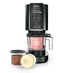 the ninja coffee maker is on display with its lid open and two jars next to it