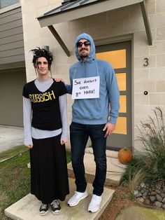 two people dressed up in costumes standing next to each other on the steps outside of a house