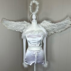 a mannequin dressed in white with angel wings