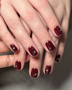 Aamirah•UK Nail Artist | @charlottetilbury inspired Christmas nails for my housemate. Dark red nails with gold chrome stars and reflective glitter centre.... | Instagram Maroon Nails With Stars, Dark Red Gel Nails Design, Short Nail Red Design, Red And Silver Nails Short, Red Celestial Nails, Red Nail Art Short Nails, Red Nail Christmas Designs, Burgundy Star Nails, Dark Red Nails With Stars