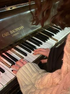 a woman is playing the piano with her hands