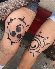 two people with tattoos on their legs