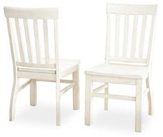 two white wooden chairs side by side on a white background with one chair facing the other