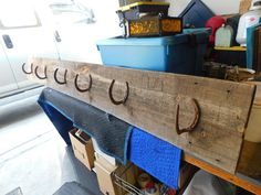 an old wooden coat rack with hooks on it and several other items in the background