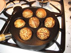 some food is cooking in a pan on top of the gas burner and it's ready to be cooked