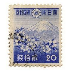 a stamp with flowers and mountains on it