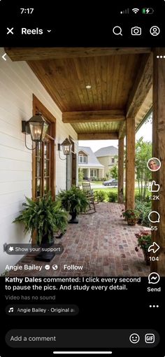 an image of a porch with plants on the front and side walk to the house