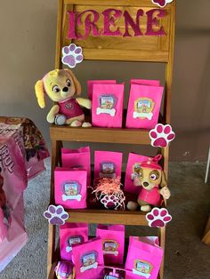 there is a display with pink bags and stuffed animals