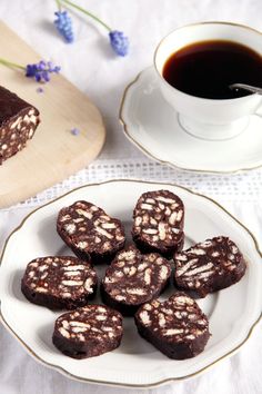 chocolate brownies on a plate next to a cup of coffee