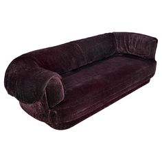 a purple couch sitting on top of a white floor