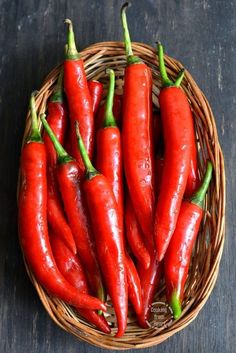 some red peppers in a basket on a table