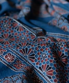 a blue and red cloth with designs on it