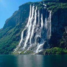 a large waterfall in the middle of a body of water