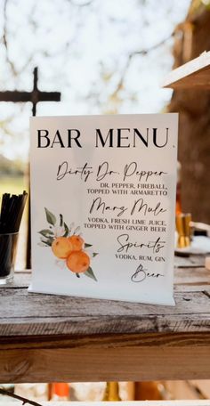 a bar menu sitting on top of a wooden table