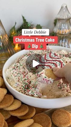 a person dipping some kind of cake into a bowl with sprinkles on it