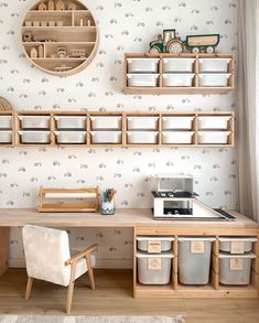 a child's playroom with toys and storage bins on the wall next to it